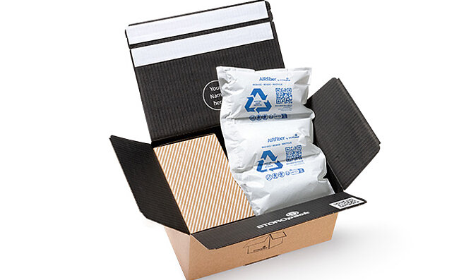 A shipping carton with a box and air pillows made of paper