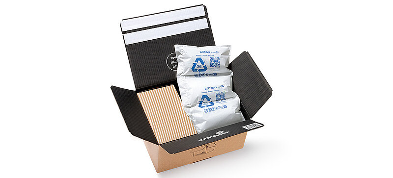 A shipping carton with a box and air pillows made of paper